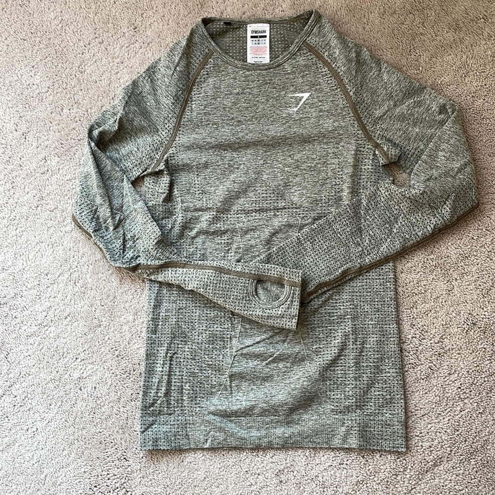 Gymshark long sleeved compression top in army green blend with finger holes.